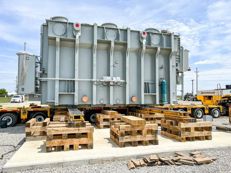 325,000-lb transformer is transloaded from trailer to pad via jack and slide