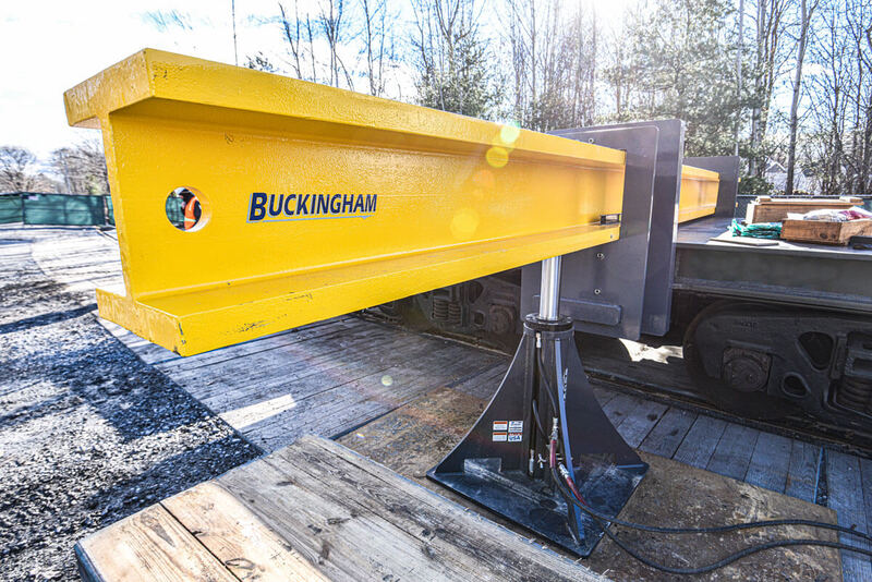 Buckingham uses 100-ton jacks under steel beams to lift a railcar from its trucks