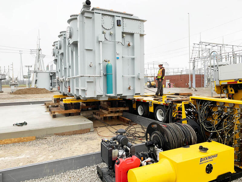 Buckingham uses a skidding system to slide transformer from a Goldhofer trailer to its pad