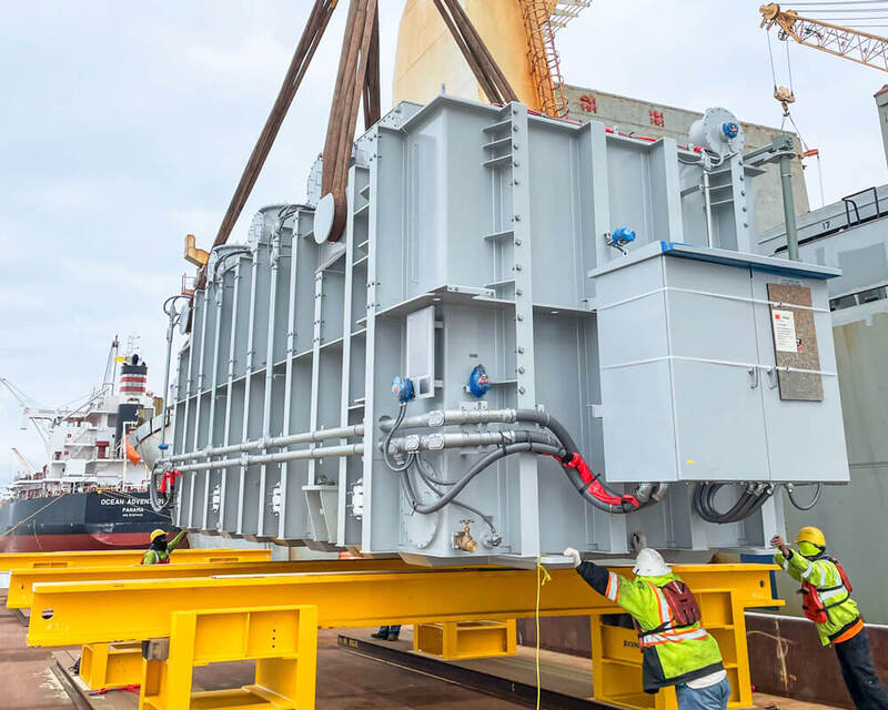 Buckingham offloads a transformer from a ship to a barge