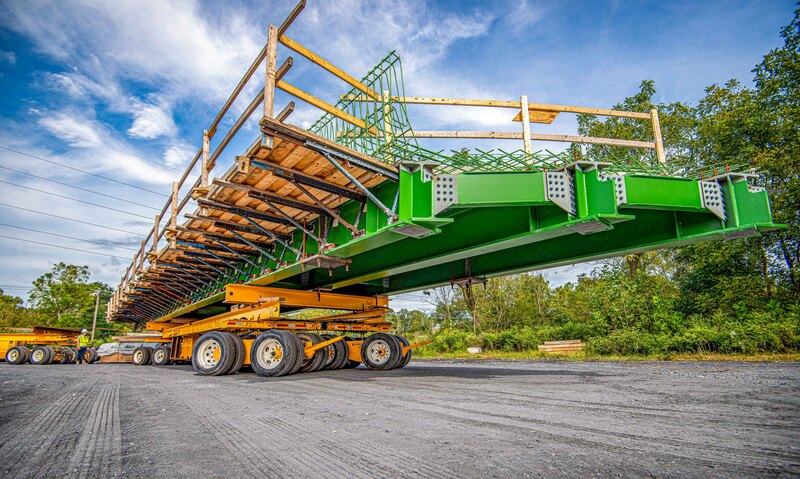 Buckingham Transport uses a custom beam and dolly transporter to haul a bridge section