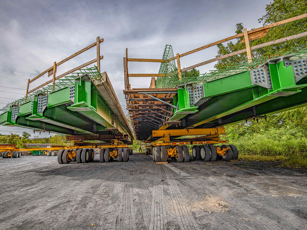 Buckingham transports a prefabricated bridge section on a self-propelled dolly system