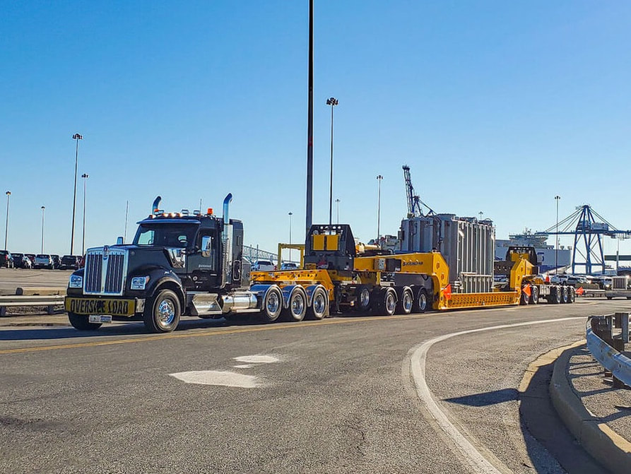 Buckingham hauls a transporter on Transmaster 13-axle expandable perimeter trailer