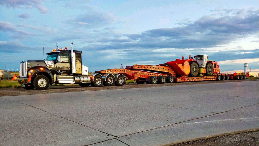 Buckingham transports a loader on a Trail King 13-Axle RGN trailer