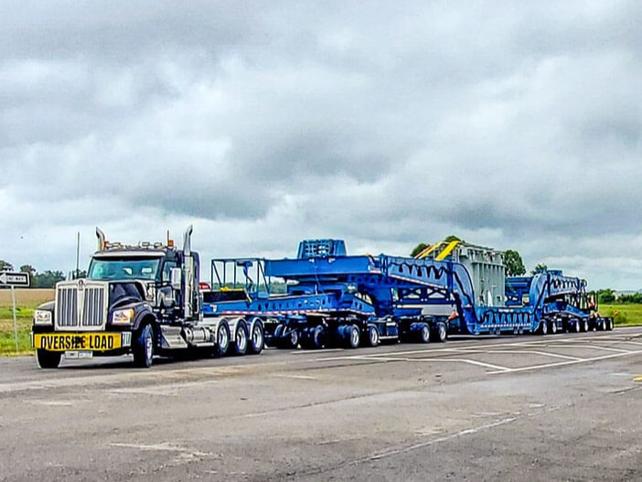Buckingham Transport moves an industrial press with a dual lane transporter