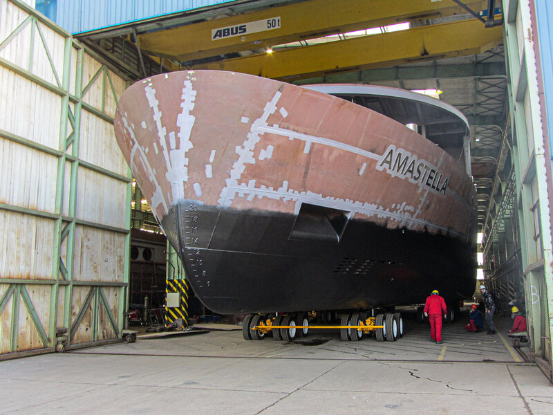 Buckingham uses a custom dolly transport to move a boat from fabrication to storage in a Serbian boat yard 